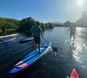 People paddleboarding on the Lower Salt River at sunrise.