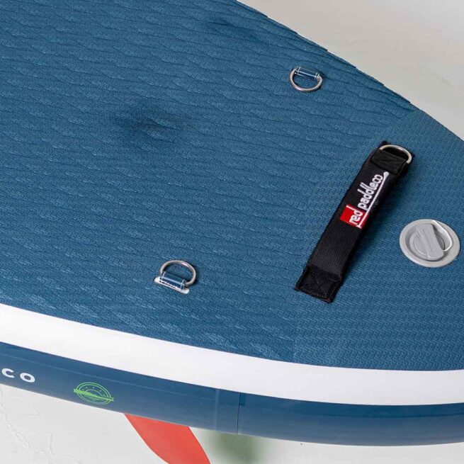 Close-up of blue textured paddleboard deck with accessories.