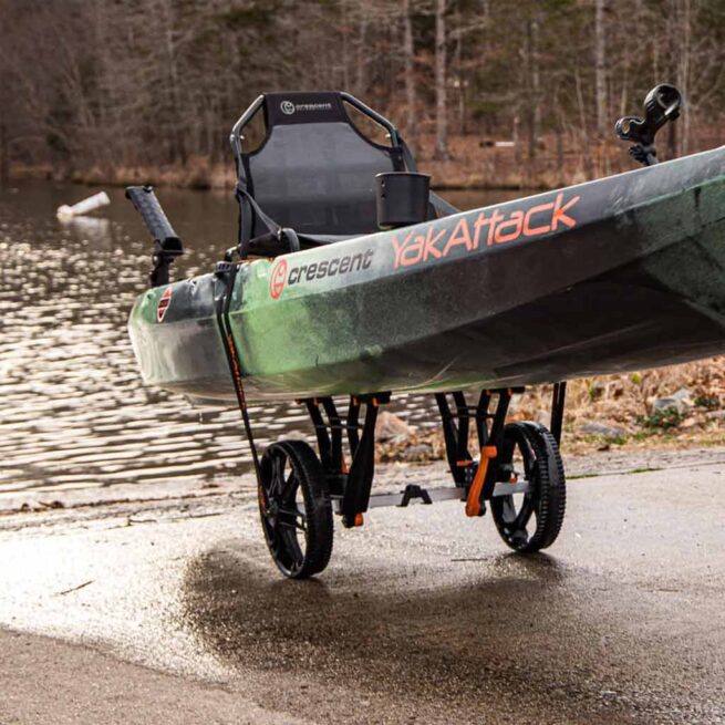 Fishing kayak on YakAttack black and orange kayak cart. Available at Riverbound Sports in Tempe, Arizona.