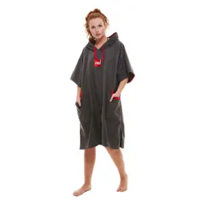 Woman modeling gray Red Paddle Co hooded quick dry changing robe with red accents front angled view. Available at Riverbound Sports in Tempe, Arizona.